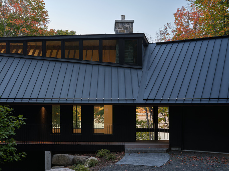 Press kit | 7600-02 - Press release | Shield and Shelter: An Embracing Lakeside Family Retreat that Opens Intimately and Sensitively to its Untamed Surroundings in the Heart of the Muskoka Region - Barbora Vokac Taylor Architect Inc. (BVT A) - Residential Architecture -  Between the garage and main living spaces, a screened Muskoka Room creates an open-air retreat. This architectural break offers visitors their first glimpse of the lake view, previously hidden by the building's placement—a subtle preview of the vistas beyond.  - Photo credit: Doublespace