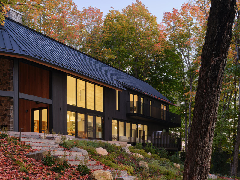 Press kit | 7600-02 - Press release | Shield and Shelter: An Embracing Lakeside Family Retreat that Opens Intimately and Sensitively to its Untamed Surroundings in the Heart of the Muskoka Region - Barbora Vokac Taylor Architect Inc. (BVT A) - Residential Architecture -  Lake-facing bedrooms open to private balconies, while the lower level leads to a terrace where a landscaped limestone stair leads down to the lakeshore.   - Photo credit: Doublespace