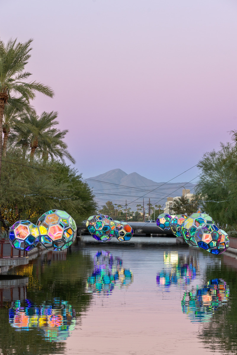 Press kit | 5595-10 - Press release | Molecules: A Series of Interactive Water Molecules Rising up from the Arizona Canal, Sparking a Connection Between Visitors and the Surrounding Environment Through Light and Sound - The Urban Conga - Multimedia Design - View looking down the Arizona canal of the work reflecting off the water.  - Photo credit: Andrew Pielage