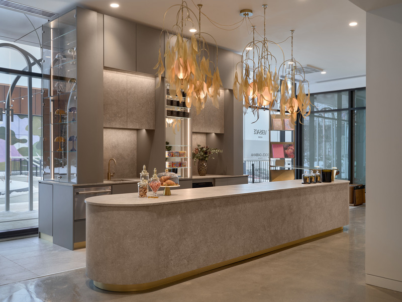 Dossier de presse | 7656-01 - Communiqué de presse | Fendi Casa, Dolce & Gabbana Casa, Versace Home, Bentley Home et Gallotti & Radice rejoignent Maison Territo au Royalmount, marquant un tournant pour le design italien à Montréal - Maison Territo - Design d’intérieur résidentiel -  Vue complète du comptoir de Maison Territo : un espace architectural pensé comme un écrin, où le design sur mesure rencontre une atmosphère de convivialité chic. Les suspensions sculpturales en laiton créées par Larose Guyon ajoutent une touche aérienne et lumineuse.  - Crédit photo :  Phil Bernard 