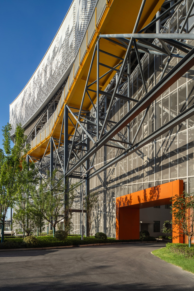 Press kit | 5086-03 - Press release | Baoshan Waste-to-Energy Center Transforms Shanghai's Industrial Legacy into Green Landmark - Ballistic Architecture Machine (BAM) - Industrial Architecture -  Detail of the perforated façade’s structural framework and elevated walkway, highlighting the interplay of transparency and industrial form.  - Photo credit: Derryck Menere
