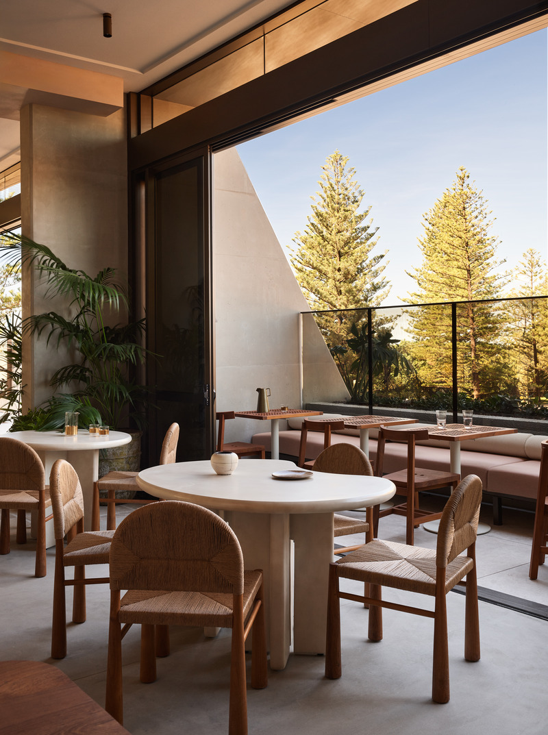 Press kit | 2887-11 - Press release | Opening Mondrian Gold Coast, Australia - Alexander &CO. - Commercial Interior Design -  Haven - Custom concrete dining tables with with view towards balcony dining and Burleigh Beach's iconic pines - Photo credit: Alicia Taylor