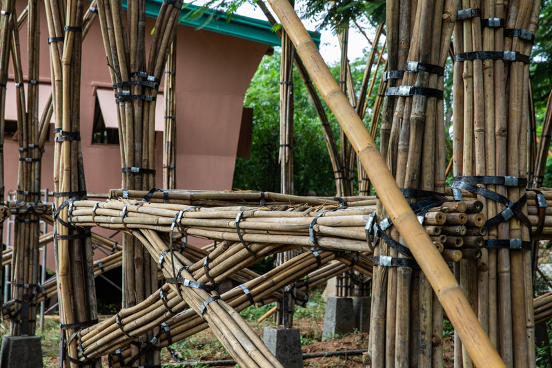 Press kit | 7035-02 - Press release | Bamboo Housing Resists 7.7 Earthquake in Conflict-Torn Myanmar, Built for Displaced Families - Blue Temple - Institutional Architecture - Close-up of the bundled bamboo joints and interlocking structural geometry during construction. - Photo credit: Aung Htay Hlaing