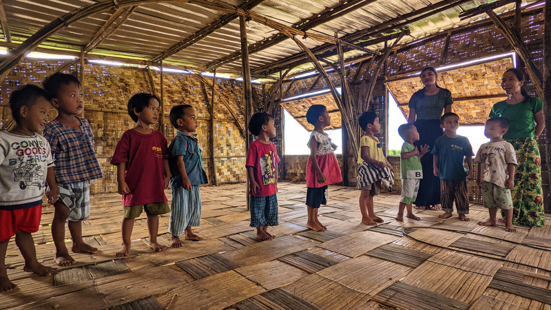 Press kit | 7035-02 - Press release | Bamboo Housing Resists 7.7 Earthquake in Conflict-Torn Myanmar, Built for Displaced Families - Blue Temple - Institutional Architecture - Children and teachers inside a bamboo classroom, part of Housing NOW’s community-built structures. - Photo credit: Raphaël Ascoli