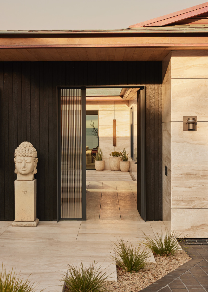 Press kit | 6087-07 - Press release | Study in Serenity: A Beachside Haven of Precision and Craftsmanship - Daniel Joseph Chenin - Residential Interior Design - The façade layers warm marble with shou sugi ban siding, crowned by a copper roof that glows against the Pacific horizon. - Photo credit: Tim Hirschmann