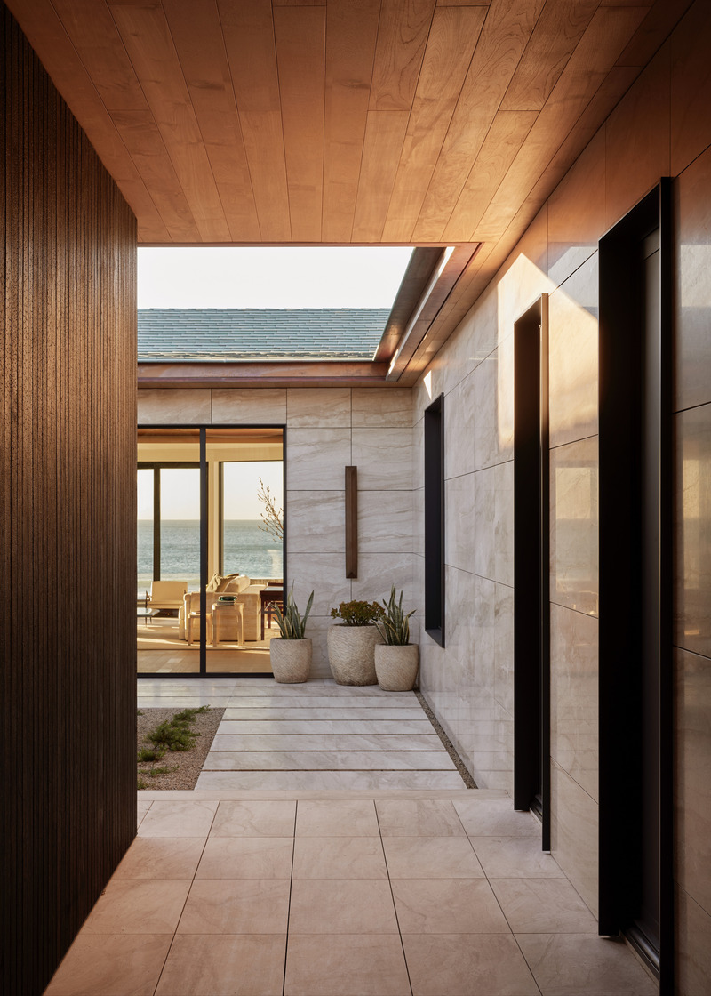 Press kit | 6087-07 - Press release | Study in Serenity: A Beachside Haven of Precision and Craftsmanship - Daniel Joseph Chenin - Residential Interior Design - The façade layers warm marble with shou sugi ban siding, crowned by a copper roof that glows against the Pacific horizon. - Photo credit: Tim Hirschmann