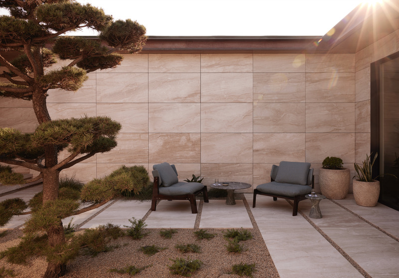 Press kit | 6087-07 - Press release | Study in Serenity: A Beachside Haven of Precision and Craftsmanship - Daniel Joseph Chenin - Residential Interior Design - A sculptural tree anchors the courtyard, its organic form a counterpoint to the precision of stone planes and clean architectural lines, while afternoon light filters across the garden, animating the walls with shifting patterns of serenity. - Photo credit: Tim Hirschmann
