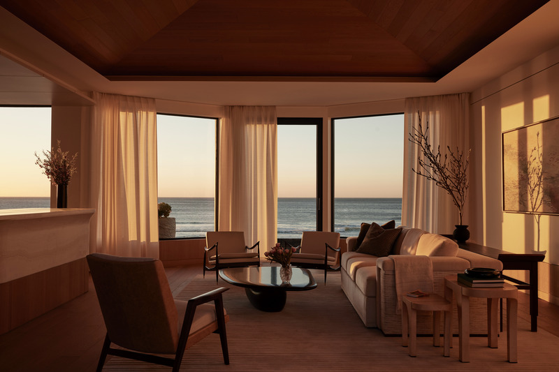 Press kit | 6087-07 - Press release | Study in Serenity: A Beachside Haven of Precision and Craftsmanship - Daniel Joseph Chenin - Residential Interior Design - Framed by a pitched oak ceiling and expansive windows, the living room unfolds as a serene gathering space where light, ocean, and architecture converge in quiet harmony. - Photo credit: Tim Hirschmann