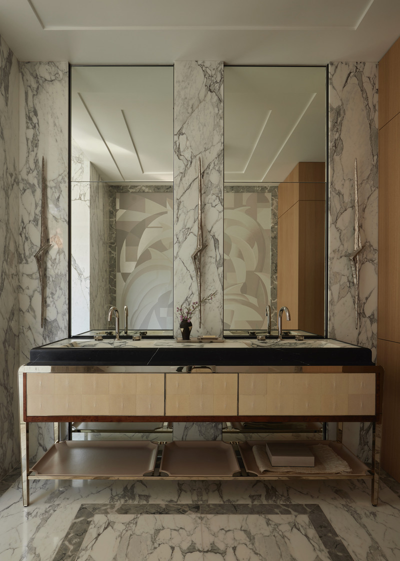 Press kit | 6087-07 - Press release | Study in Serenity: A Beachside Haven of Precision and Craftsmanship - Daniel Joseph Chenin - Residential Interior Design - In the primary bath, a custom vanity by Daniel Joseph Chenin, realized in marble, nickel, burl wood, and stingray, anchors the space, paired with a bespoke wallcovering conceived by Chenin and brought to life by de Gournay. Sculptural sconces by Charles Paris heighten the room’s sense of artistry and precision. - Photo credit: Tim Hirschmann