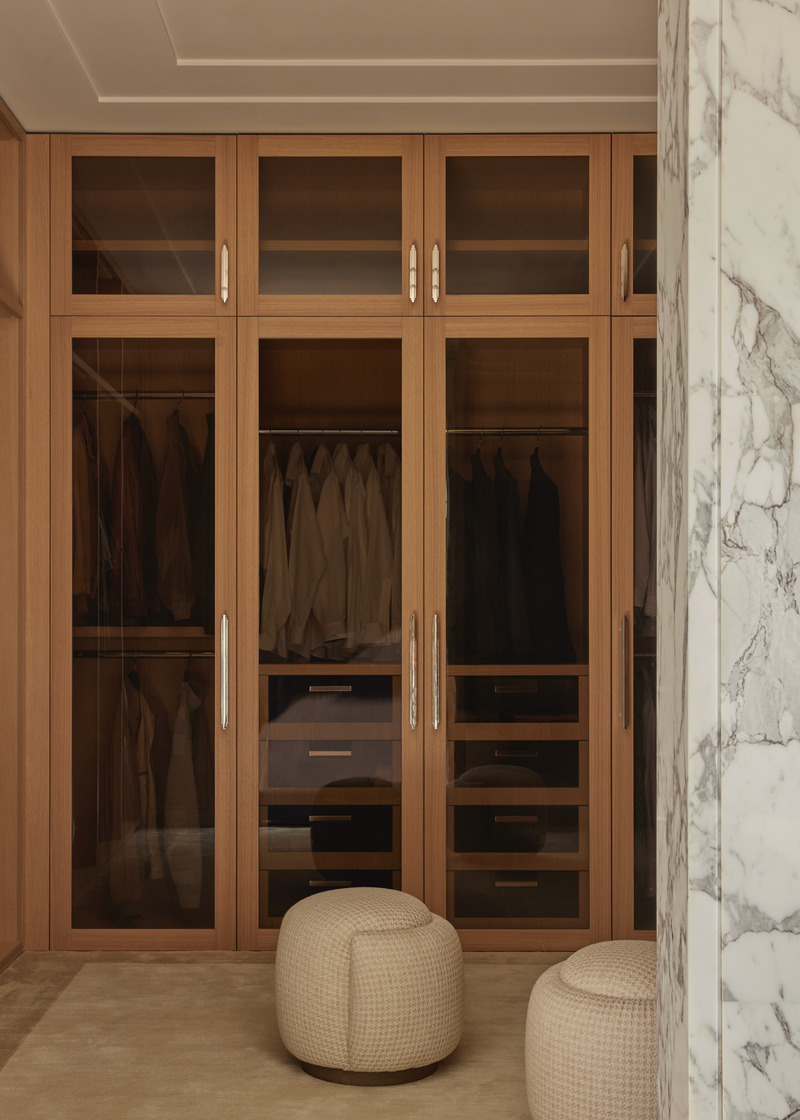 Press kit | 6087-07 - Press release | Study in Serenity: A Beachside Haven of Precision and Craftsmanship - Daniel Joseph Chenin - Residential Interior Design - The custom closet by Daniel Joseph Chenin combines tailored oak millwork with hardware by Nanz, creating a refined balance of precision and warmth within the marble-clad suite. - Photo credit: Tim Hirschmann