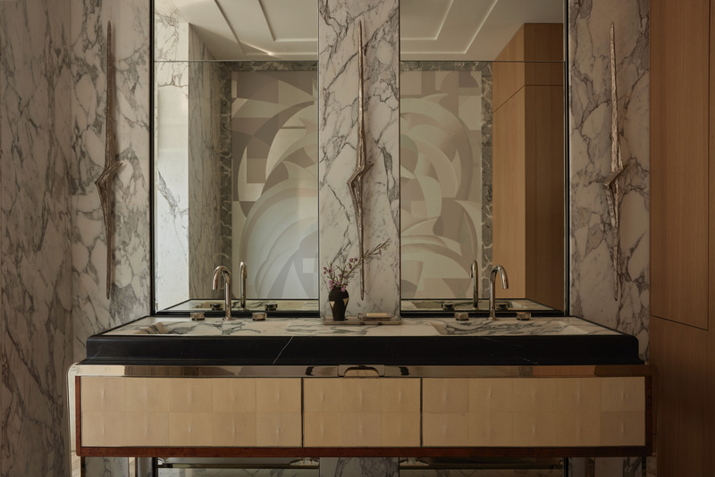 Press kit | 6087-07 - Press release | Study in Serenity: A Beachside Haven of Precision and Craftsmanship - Daniel Joseph Chenin - Residential Interior Design - In the primary bath, a custom vanity by Daniel Joseph Chenin, realized in marble, nickel, burl wood, and stingray, anchors the space, paired with a bespoke wallcovering conceived by Chenin and brought to life by de Gournay. Sculptural sconces by Charles Paris heighten the room’s sense of artistry and precision. - Photo credit: Tim Hirschmann