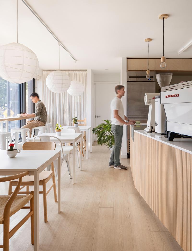 Press kit | 1513-09 - Press release | Lion Coffee - Dubbeldam Architecture + Design - Commercial Interior Design - The design is anchored by the long service counter that spans the length of the space, featuring a sculptural, fluted wood front and a sleek white quartzite countertop. - Photo credit: Scott Norsworthy