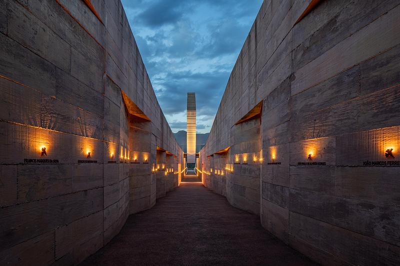 Dossier de presse | 7817-01 - Communiqué de presse | Memorial Brumadinho - Atiaîa Lighting Design - Design d’éclairage - <p class="">The path is a 230m cleavage, a literal and symbolic rift that cuts through the terrain to point towards the exact site of the dam failure. Ipê flowers, symbol of life and resilience, remember the flame of candle lights and evoke a procession. </p> - Crédit photo : Pedro Mascaro