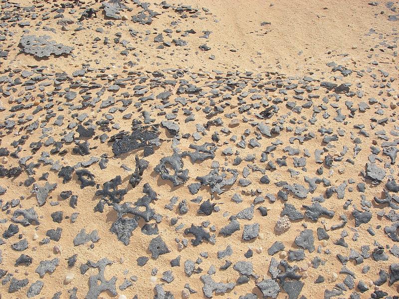 Press kit | 748-54 - Press release | UQAM’s Centre de design Presents "Toxicité coloniale : Architecture et paysage radioactifs français dans le Sahara" - Centre de design de l'UQAM - Event + Exhibition - <p style="">"Blue Gerboise" sand, 2007. Photo credits: Bruno Barrillot. Various metals and materials abandoned in the Sahara around the former Saharan Military Testing Center, Reggane, 2007.</p> - Photo credit: Bruno Barrillot. With kind permission of the Armaments Observatory (https://www.obsarm.info/).