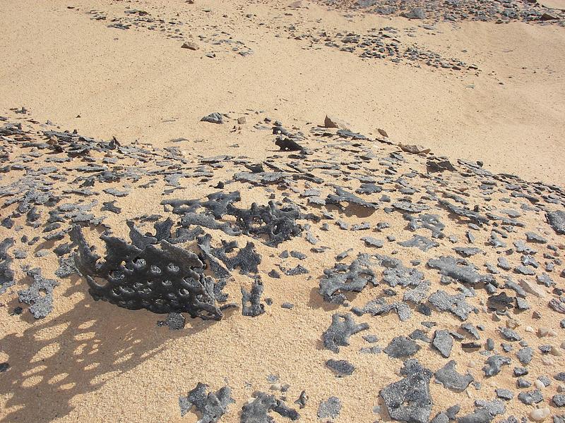 Press kit | 748-54 - Press release | UQAM’s Centre de design Presents "Toxicité coloniale : Architecture et paysage radioactifs français dans le Sahara" - Centre de design de l'UQAM - Event + Exhibition -  <p style="">"Blue Gerboise" sand, 2007<br>Various metals and materials abandoned in the Sahara around the former Saharan Military Testing Center, Reggane, 2007.</p>  - Photo credit: Bruno Barrillot. With kind permission of the Armaments Observatory (https://www.obsarm.info/). 