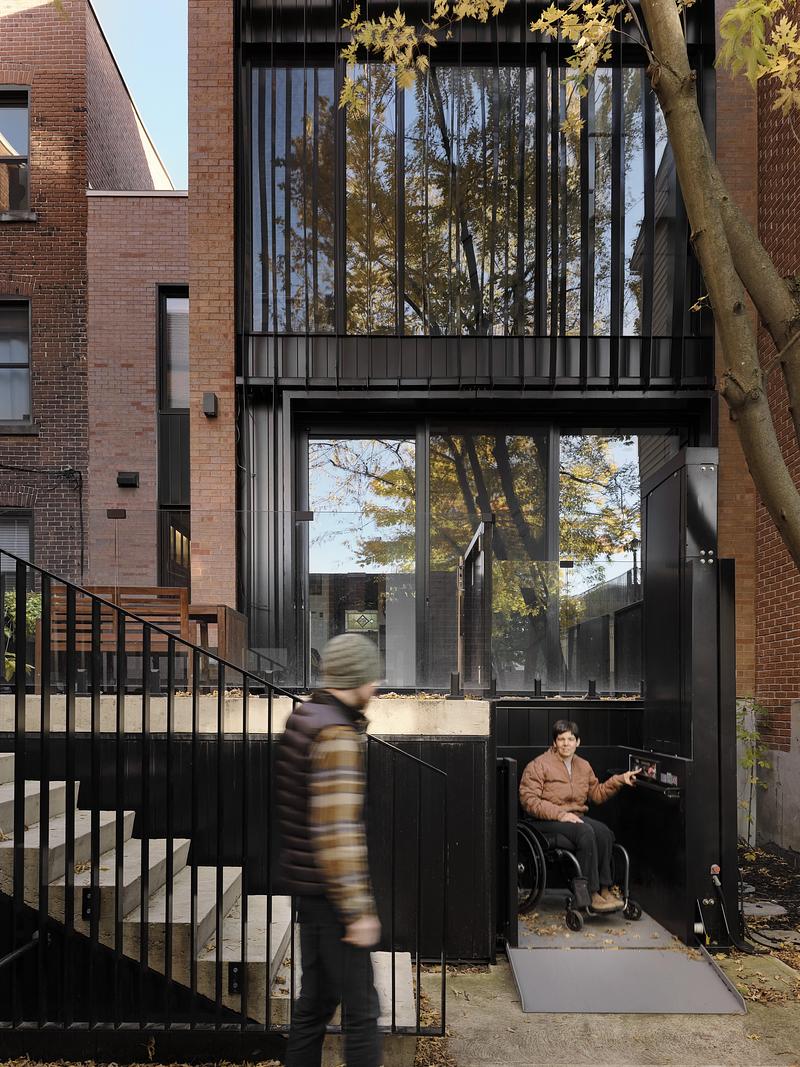 Press kit | 1676-11 - Press release | Living Differently,   without Compromise - ADHOC - Residential Architecture - The main intervention takes place at the back of the house where an elevator connects all floors of a three-storey extension. A new staircase wraps around it, allowing Mikkel and able-bodied visitors to move through the building alongside Cait. - Photo credit: Maxime Brouillet