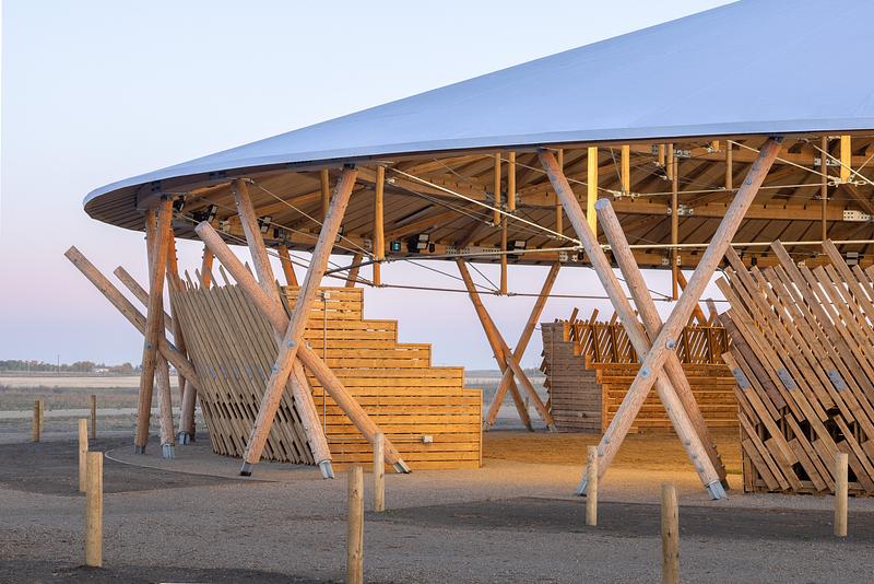 Press kit | 7916-01 - Press release | Rooted in Culture: The Muscowpetung Powwow Arbour Wins Architizer A+ Award and Canada's Governor General’s Medal in Architecture - Oxbow Architecture & Richard Kroeker - Institutional Architecture - <p class="">Exterior image of Arbour at daybreak showing bleacher screening</p> - Photo credit: Lindsay Reid<span></span>