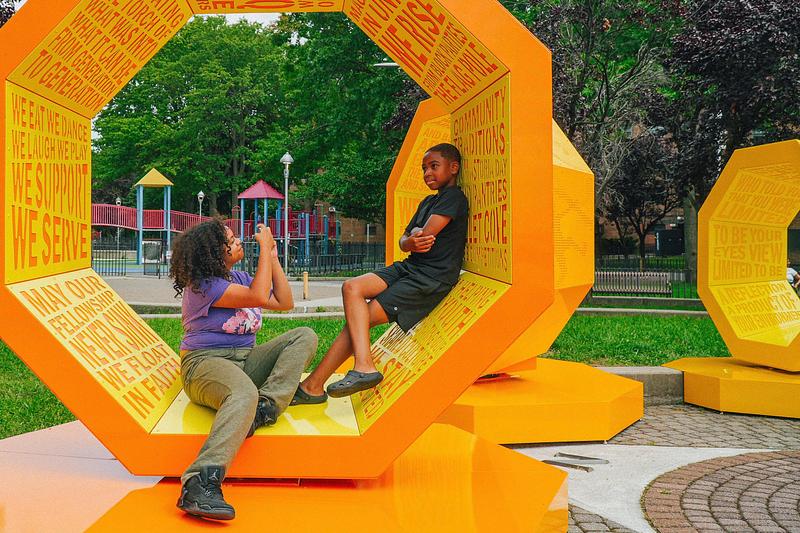 Press kit | 5595-13 - Press release | The Urban Conga Unveils “Revolving Voices” at New York Public Housing in Collaboration with Local Poet Tamra Cosby - The Urban Conga - Art - <p>Users can lounge within the structures and rotate them to change the orientation within the space.</p> - Photo credit: Tameek Williams