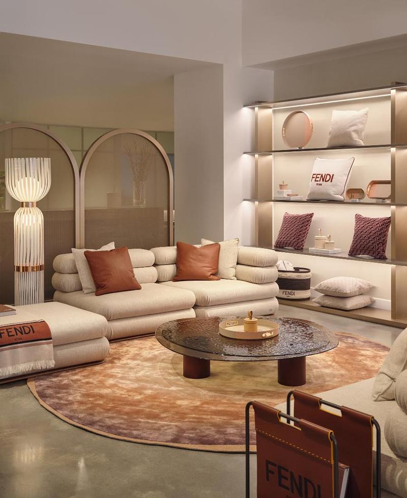 Press kit | 7656-03 - Press release | This Winter, the Most Desirable Fendi Isn't Worn - Maison Territo - Commercial Interior Design -  Embroidered “FENDI Roma” cushion on the illuminated shelves, with a FENDI throw and leather magazine rack, in the Fendi Casa space of Maison Territo’s Royalmount showroom.  - Photo credit: Phil Bernard
