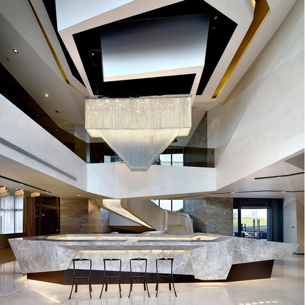 Press kit | 902-02 - Press release | A’ Design Awards 2014 Winners Announced - A' Design Award and Competition - Competition -   TIMES BUND CLUBHOUSE <br>Club House by Kris Lin<br><br>PROJECT DESCRIPTION:<br>This is a project which combines the functions of both club and sales center. 1st floor is mainly focused on the function of sale center while combining the function of bar and multi-functional conference room. 2nd floor is only for the sales office. Floor B1 is partially the fitness club，which comprising of a theme swimming center, gym, dancing room and basketball room. The design solution is hopefully to break the traditional horizontal and vertical space vision through the approach of innovation. The whole solution utilizes geometric modeling to realize space design and 3D modeling. The solution explores brand new ideas through three-dimensional space and is trying to create a space of body and art, meanwhile focusing on quality in the process of innovation and a careful selection of materials to keep an air of nobility. The building comprises of three floors, floor B1, 1st floor and 2nd floor. Vertical stair space is used to connect the three floors. The stair is designed in a form of flow line as if it flows down from 2nd floor to floor B1 and it is also like a sculpture. Since there are lots of equipments in the ceiling of swimming center and the building roof itself is beveled, so the ceiling space is rugged. For this reason the ceiling of swimming center is designed with the idea of flow wave.&nbsp;<br>   - Photo credit: Kris Lin, 2013.