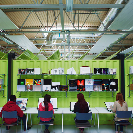 Press kit | 902-02 - Press release | A’ Design Awards 2014 Winners Announced - A' Design Award and Competition - Competition - Architecture Factory <br>Cork Institute of Technology by Marc O Riain &amp; Neil Tobin<br><br>PROJECT DESCRIPTION:<br>The Architecture Factory is a third level education and learning space situated in a disused split-level warehouse. The brief was informed primarily by cost effective occupancy and the desire for studio pedagogy. The design avoided traditional subdivision of walls and ceilings; requiring sub divided servicing and expensive firewalls. 6 shipping containers function as lecturer's offices dividing the space it into open studios separated from a mezzanine by an open boulevard acting as an exploration-learning lab, an opportunistic exhibition space, and the main circulation. Creating a visually open connection between occupants to encourage interaction between peer groups. Below the mezzanine frameless glazing minimally delineate the recessed acoustic boundaries avoiding a long monolithic horizontal interior façade. The balcony anamorphically distorts the perspectival emphasis. First floor transparencies offer excitement and vista to the activities below. Green shipping containers, reuse embodied energy and radiate a chromatic energy within the space. Roof sections are serrated creating a repetitive texture angled southward for light and away from the mezzanine windows for privacy. The resulting textural composition creates differing cognate compositions depending on whether they are viewed from above or below. Open plan studios occupy parti spaces between geometric organizations of containers in un-partitioned relief. Dedicated work-spaces with wire shelving above, function as both storage and acoustic baffle. The 6 acoustically open offices and studios function intelligibility well. Enclosed seminar rooms below the mezzanine provide more acoustically private spaces for theory delivery and discussion. Student-to-student learning is a natural consequence. The industrial heritage of the building strongly influenced how the scheme aesthetic maintained the genius loci. The use of containers reflects the manufacturing process. The white and grey provides an interior canvas carefully refined to minimize complexity. Color proportionality and density emphasizes the containers but is sensitively balanced not to perceptively dominate the space.&nbsp;<br> - Photo credit:  Janice O Connell F22 Photography 