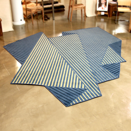 Press kit | 902-02 - Press release | A’ Design Awards 2014 Winners Announced - A' Design Award and Competition - Competition - Folded Tones&nbsp;<br>Rug by Enoch Liew<br><br>PROJECT DESCRIPTION:<br>Three-dimensionality and the illusion of depth were achieved with just three colours. It was a conscious effort to limit the number of colours for adaptability and flexibility. The variety of tones and depth of the rug is dependent on the width and density of the stripes, rather than a large palette of colours that may jar with a particular space.&nbsp; - Photo credit: Enoch Liew, 2013.