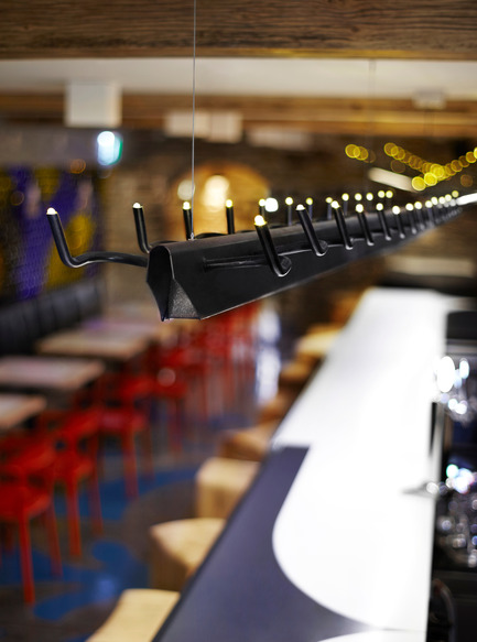 Press kit | 1048-09 - Press release | Spanish-inspired tapas restaurant Barsa Taberna captures the energy of the running of the bulls - +tongtong - Commercial Interior Design - Above the bar, three custom-designed LED light fixtures hang. With a motif of bullhorns, the armatures resemble a charging bull caught under a strobe light, frozen in a stop motion sequence.<br> - Photo credit: Lisa Petrole Photography<br>