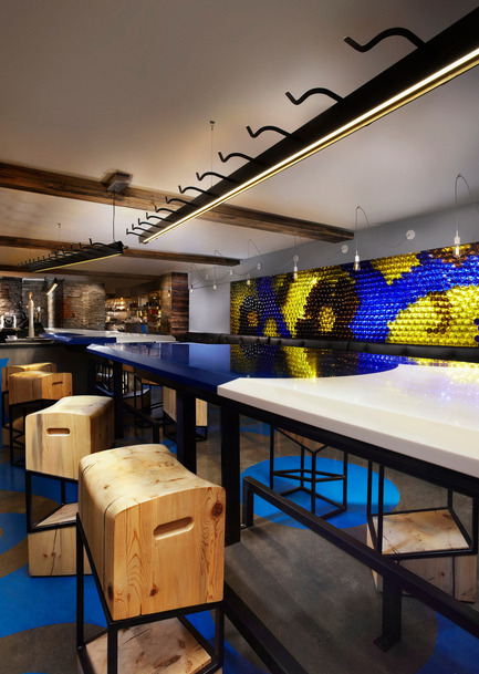 Press kit | 1048-09 - Press release | Spanish-inspired tapas restaurant Barsa Taberna captures the energy of the running of the bulls - +tongtong - Commercial Interior Design - View of the two-tone Corian Bar, which becomes two-sided, flanked by custom designed stools made of salvaged, old-growth pine with an oblique powdered coated steel frame. Dubbed the "little pest", or in Spanish "Becho mio".<br> - Photo credit: Lisa Petrole Photography&nbsp;<br>