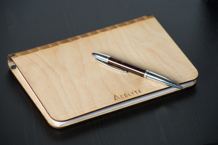 Press kit | 884-04 - Press release | HEC Project 2014 Edition - Faculté d'aménagement de l'Université de Montréal - Industrial Design - Acolyte<br><br>The  acolyte is a sketchbook made out of Russian birch plywood which was  laser cut and within which one can easily switch-out the sheets (8 ½ x  11) due to the elastic holding them in place. It is the perfect  accomplice to your creativity.<br><br>Tara Harb<br>Maxim Lamirande<br>Gaëtan Nkamegue - Photo credit: Olivier Ouimet 2014 - www.olivierouimet.com