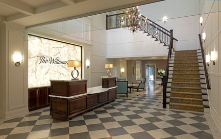 Dossier de presse | 1855-01 - Communiqué de presse | Newcombe Design Group’s approach to retirement living honoured with ARIDO Award - Newcombe Design Associates - Design d’intérieur commercial - The soaring lobby, concierge desk, lighting, feature stair and subdued color palette instantly convey the hotel-like character of this retirement residence. While meeting the clients’ request for a checkerboard tile floor pattern, we used a medium grey and cream stone tile in a matte finish to soften the contrast and glare - Crédit photo : David Whittaker