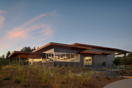 Press kit | 2039-01 - Press release | Titus Vineyards - MH Architects - Industrial Architecture -      The Southwest corner of Titus Winery is characterized by the covered hospitality area overlooking surrounding vineyards. &nbsp;Exterior materials include cedar soffits, concrete board-form tilt-up walls, gunmetal blue panels above windows, and anodized aluminum window frames.    - Photo credit:  Technical Imagery Studios  