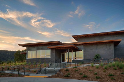 Press kit | 2039-01 - Press release | Titus Vineyards - MH Architects - Industrial Architecture -  The Southwest corner of Titus Winery is characterized by the covered hospitality area overlooking surrounding vineyards. &nbsp;Exterior materials include cedar soffits, concrete board-form tilt-up walls, gunmetal blue panels above windows, and anodized aluminum window frames.   - Photo credit: Technical Imagery Studios&nbsp;