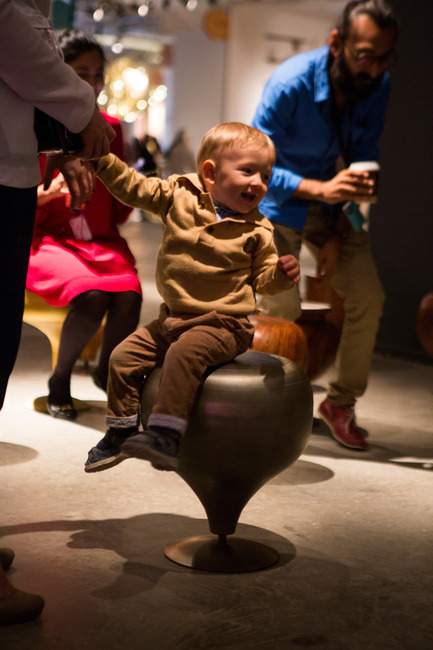 Press kit | 1604-06 - Press release | Design Days Dubai Completes It Fifth And Most Successful Edition To-Date - Design Days Dubai - Event + Exhibition -  Child enjoying the spinning 'Lattoo' stool by Coelesce (Pakistan), &nbsp;Design Days Dubai 2016  - Photo credit: Design Days Dubai (2016)