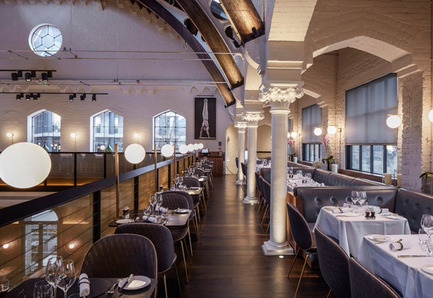 Dossier de presse | 1124-09 - Communiqué de presse | WIN Awards - Hospitality Shortlist Announced - World Interiors News - Design d’intérieur commercial - WIN Awards 2016 - Restaurants Category:&nbsp;The German Gymnasium by Conran &amp; Partners (United Kingdom)&nbsp;<br><br>Conran &amp; Partners were commissioned to create a glamorous yet democratic contemporary European Grand Café, Bar and Restaurant to complement the newly invigorated King’s Cross master plan, and transform the Grade II-listed building into a unique destination. Our concept is a refined modern insertion within the existing building; a Bauhaus version of a European Grand Café.<br><br>‘The ground floor dining area, suffused with natural light which captures the building’s delicate silhouettes of cast steel columns and Victorian archways, makes an immediate impact. Two new contemporary black steel staircases symmetrically frame the space, adding drama and elegance.<br><br>Everyone was incredibly impressed by the opportunity of the existing building, at the same time understanding the challenges of the existing elements. The gallery, which has been exposed, is very restrained. On paper it shouldn’t work because it is only one table deep, but it does work as a proper gallery and vantage point. The composition of the seating creates very nice zones and the restrained palette is sympathetic to the existing building. A well-received project.’ JD<br> - Crédit photo : Conran &amp; Partners