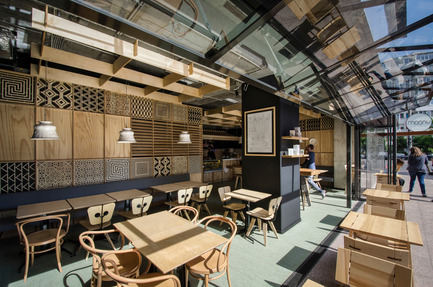 Dossier de presse | 1124-09 - Communiqué de presse | WIN Awards - Hospitality Shortlist Announced - World Interiors News - Design d’intérieur commercial - WIN Awards 2016 - Cafés Category:&nbsp;The Moony Café by Corvin Cristian (Romania)<br><br>The richness of details comes from a mix match of references to the culture of coffee and to the faraway lands where it comes from. Still it manages to maintain a clean, almost minimal overall image given the reduced number of textures (plywood, porcelain, black paint).&nbsp;<br><br>Ethnic patterns from Africa, Asia and South America or Arabic motifs in cut out plywood combine with especially designed lamps and insets inspired by the shape of the Austrian coffee cups and chinaware and typical Viennese café Thonet chairs.<br><br>‘This one has a very interesting approach; they’ve taken ethnic and cultural references and put them together under a holistic banner. The laser cut panels give a very nice, restrained decorative element. The narrative is nicely layered, and on top of that, the restaurant is zoned very nicely. There are some little bits of intrigue in there that you look twice at. Altogether an unusual project that breaks the mould of many generic projects that we see.’ JD<br> - Crédit photo : Corvin Cristian