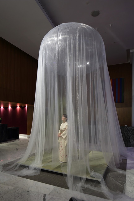 Press kit | 2051-04 - Press release | Japan Unlayered Officially Opens - Westbank | Peterson - Event + Exhibition -         Floating Teahouse in the entrance lobby of Fairmont Pacific Rim -&nbsp;the traditional Japanese teahouse is given contemporary treatment with a 130 square metre 'Super Organza' fabric roof, made of 27 micron polyester (one sixth the thickness of a strand of hair), suspended from a translucent helium balloon - Photo credit: Ema Peter