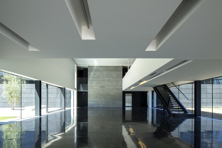 Dossier de presse | 2613-01 - Communiqué de presse | Faber Headquarters - GEZA - Gri e Zucchi architetti associati - Architecture industrielle -         The entrance hall is characterized by a black terrazzo floor that mirrors the two green courtyards - Crédit photo : Massimo Crivellari