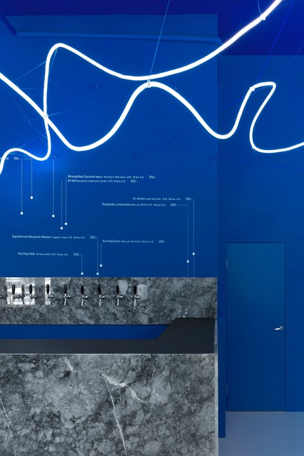 Press kit | 2247-04 - Press release | Galaxy Bar and Bottle Shop - Maxim Kashin Architects - Commercial Interior Design - Grey marble counter, blue walls and neon flex light installation - Photo credit: Dmitry&nbsp;Chebanenkov