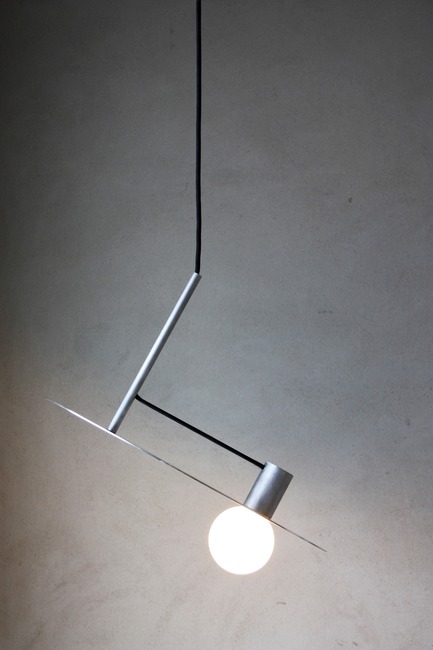 Press kit | 1895-04 - Press release | L A M P Finalists Announced for Fifth Annual International Lighting Design Competition - L A M P (Lighting Architecture Movement Project) - Lighting Design -                  L n°004 by Pierric De Coster from         Antwerp, Belgium. The pendant lamp is characterized by its simplicity and pure form. Stripped of all unnecessary, a logical composition of cylindrical shapes creates a subtle and poetic object.        The lamp only consists of three cylindrical aluminum pieces, a light source and a power cord.  - Photo credit:  L A M P 