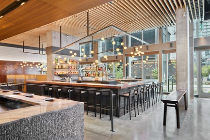 Press kit | 2886-02 - Press release | Wild Ginger Denny Triangle - SkB Architects - Commercial Interior Design -  Central bar area and dining with custom light fixture feature Bocci globes above  - Photo credit: Ben Benschneider