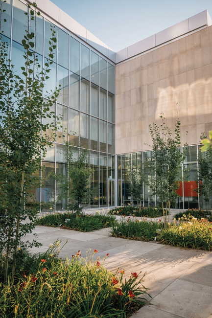 Press kit | 2073-09 - Press release | Discover the new Royal Alberta Museum - DIALOG - Institutional Architecture - The Fraser Courtyard brings to life the old 98 Street that was previously lost to downtown Edmonton development.&nbsp;Aspen trees are planted here, forming a high canopy to accommodate cafe seating underneath. Day Lilies are planted below the Aspen trees—a breed developed by researchers in Alberta before rising to popularity around North America. - Photo credit: Tom Arban Photography Inc