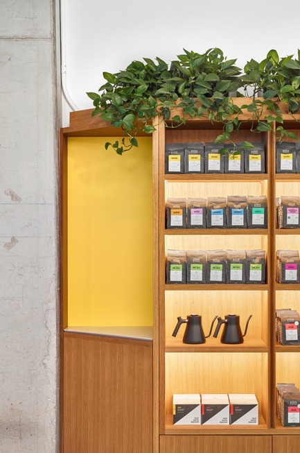 Press kit | 2682-01 - Press release | Innovation Through Design - The Symbiotic Link Between Branding and Architecture - Williamson Williamson Inc. - Commercial Interior Design -   Pilot Ossington Ave. Cafe: A detail of the oak shelving features a Pilot Yellow niche.&nbsp;<br>[Completion Date: 2019]<br>   - Photo credit: Scott Norsworthy