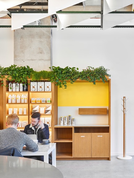 Press kit | 2682-01 - Press release | Innovation Through Design - The Symbiotic Link Between Branding and Architecture - Williamson Williamson Inc. - Commercial Interior Design -   Pilot Ossington Ave. Cafe: The milk unit is incorporated into the oak cabinetry.&nbsp;<br>[Completion Date: 2019]<br>   - Photo credit: Scott Norsworthy