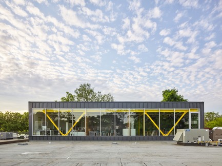 Press kit | 2682-01 - Press release | Innovation Through Design - The Symbiotic Link Between Branding and Architecture - Williamson Williamson Inc. - Commercial Interior Design -   Pilot Wagstaff Office Addition: Exterior View showing the Pilot Yellow truss which spans the exterior walls and supports the addition without columns below.<br>[Completion Date: 2018]<br>    - Photo credit:  Scott Norsworthy 
