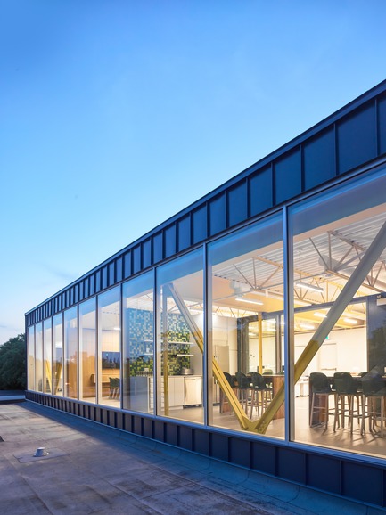 Press kit | 2682-01 - Press release | Innovation Through Design - The Symbiotic Link Between Branding and Architecture - Williamson Williamson Inc. - Commercial Interior Design -    Pilot Wagstaff Office Addition: The structural steel trusses provide a contrast to the regular rhythm of the curtain wall and standing seam facade.&nbsp;<br>[Completion Date: 2018]<br>     - Photo credit: Scott Norsworthy