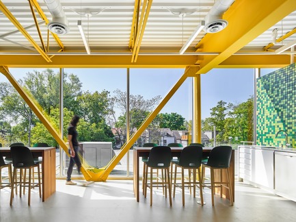 Press kit | 2682-01 - Press release | Innovation Through Design - The Symbiotic Link Between Branding and Architecture - Williamson Williamson Inc. - Commercial Interior Design -    Pilot Wagstaff Office Addition: A view of the lunchroom featuring the structural truss and cross beam.&nbsp;<br>[Completion Date: 2018]<br>     - Photo credit: Scott Norsworthy