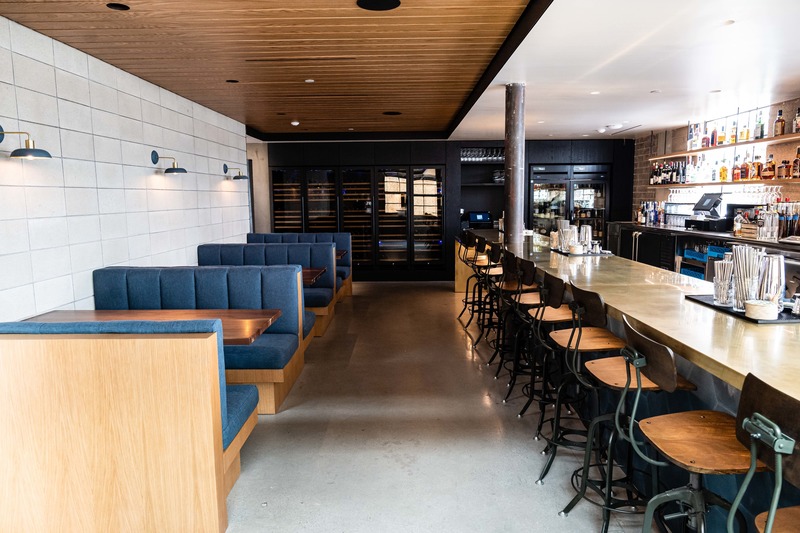 Press kit | 2757-10 - Press release | Montalba Architects Unveils New Hospitality Projects - Montalba Architects - Commercial Architecture - In the bar, a wood ceiling feature and upholstered seating pair with the industrial palette to create a warm, yet modern vibe.<span></span> - Photo credit: Jim Sullivan