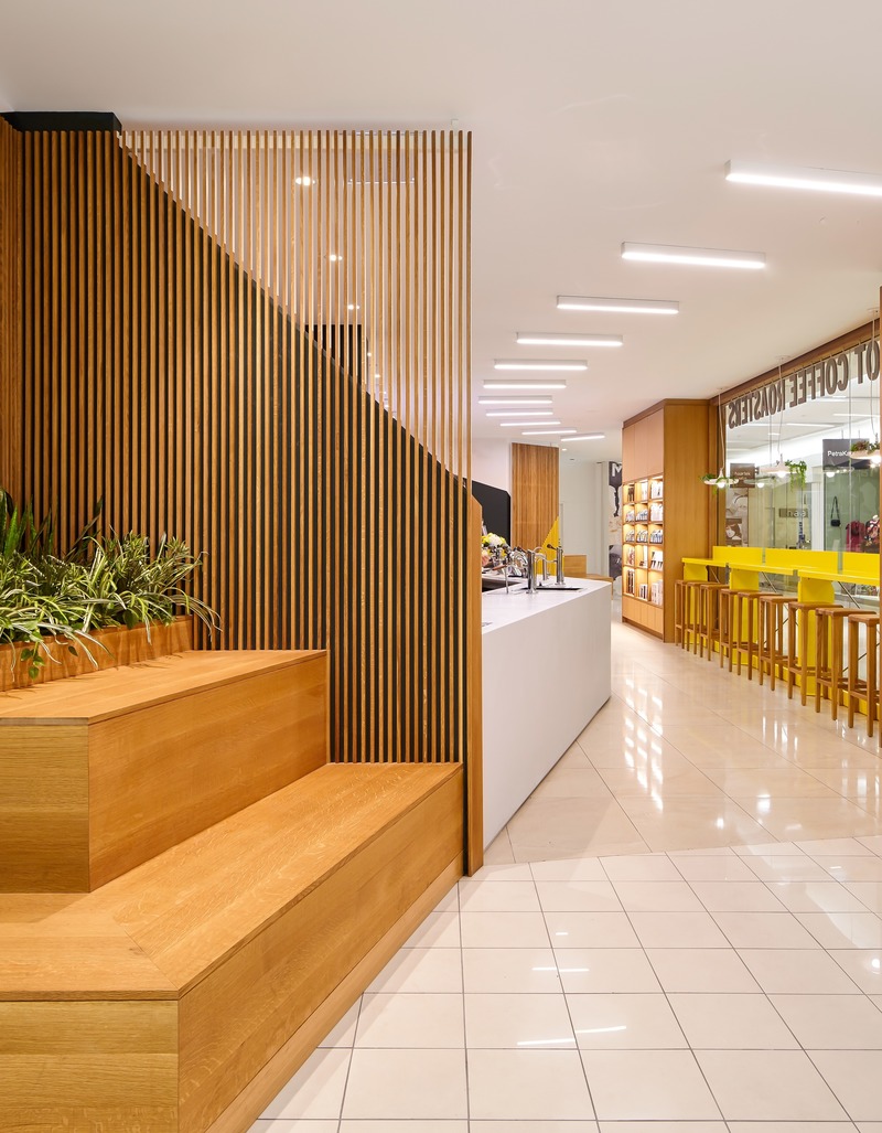 Press kit | 2682-01 - Press release | Innovation Through Design - The Symbiotic Link Between Branding and Architecture - Williamson Williamson Inc. - Commercial Interior Design - Pilot Manulife: When the slatted gates are open, the glazed wall acts as an island that customer flow around and into the cafe.  - Photo credit: Scott Norsworthy