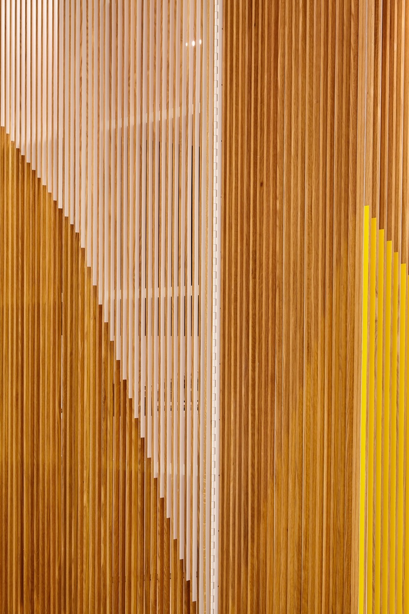 Press kit | 2682-01 - Press release | Innovation Through Design - The Symbiotic Link Between Branding and Architecture - Williamson Williamson Inc. - Commercial Interior Design - Pilot Manulife: The gates hinge on custom painted piano hinges that run the length of the slats.  - Photo credit: Scott Norsworthy