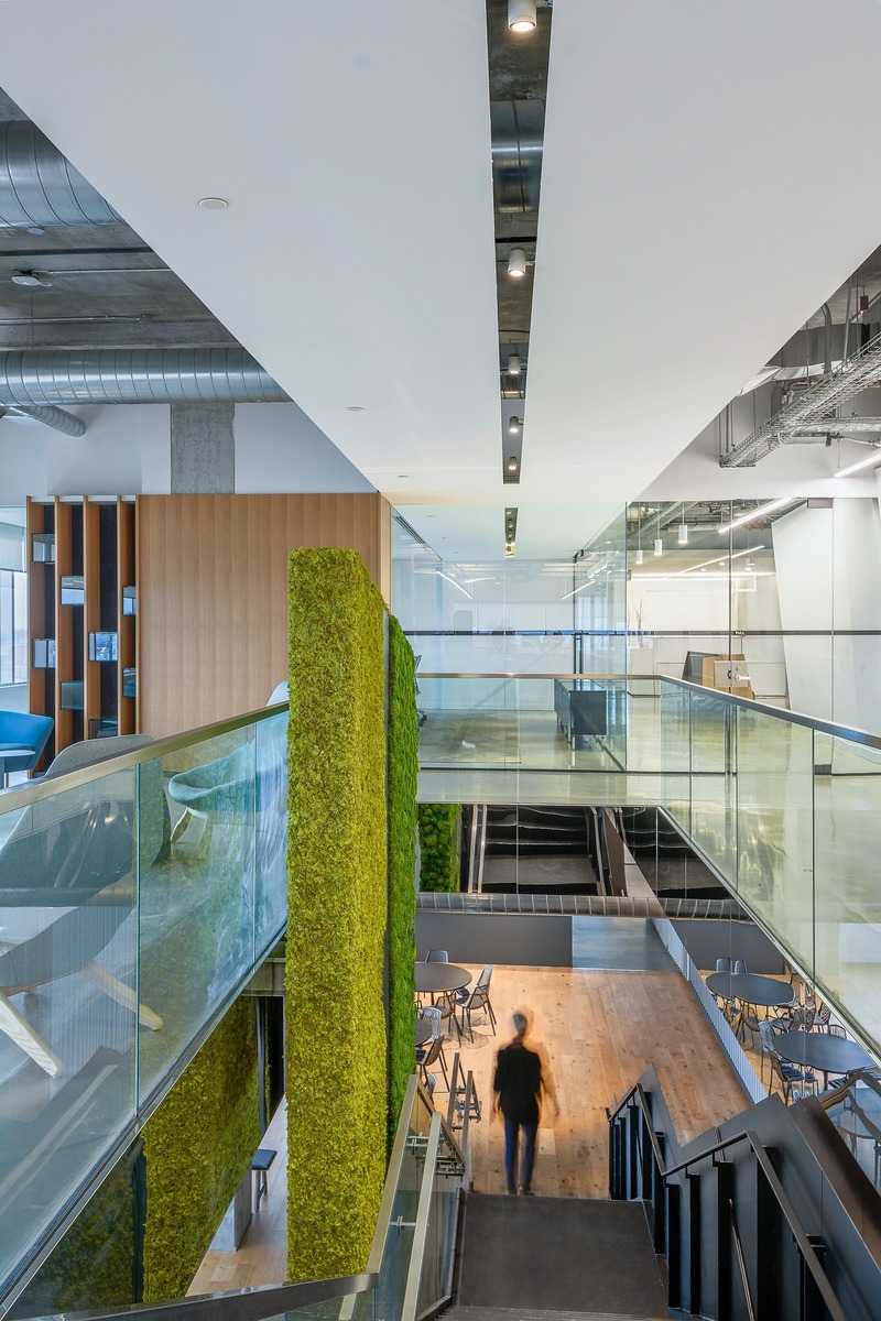 Press kit | 2403-01 - Press release | Telecon across Canada - Imperatori Design - Commercial Interior Design -  Telecon Toronto - Access to café<br><br><p class="">The sculptural black metal staircase anchors the scene with its integrated 2 storey high living green wall. The staircase connects the 4th and 3rd floor where staff have access to the café, various types of meetings rooms and diverse types of seating areas. </p>  <p class=""><br></p><p class="">The suspended ceiling above the staircase guides the eyes to the c-suite boardroom where company decisions are made in all transparency. The sculptural staircase, biophilic context and strategic design cues together offer guests and staff a memorable experience. </p><br style=""> - Photo credit: Ray Van Dusen